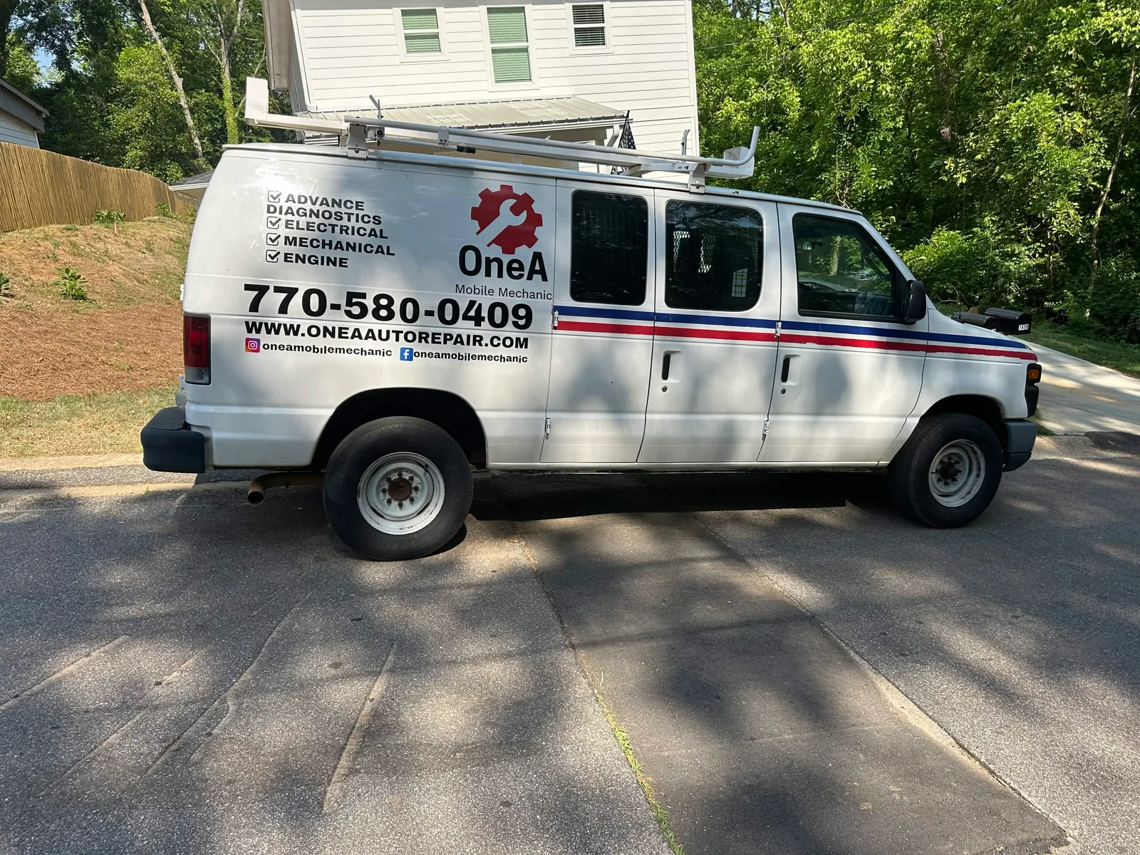 The OneA Mobile Auto Repair service van at a residential driveway